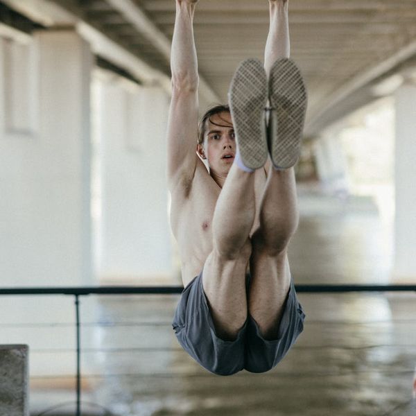 A man in deep concentration during a flexibility exercise.
